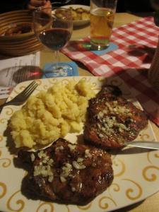 Pork Neck Steaks with potato salad and a glass of red wine - Munich